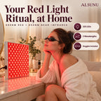 Woman in a robe relaxing with eye goggles in front of the glowing red light panel on her vanity at home