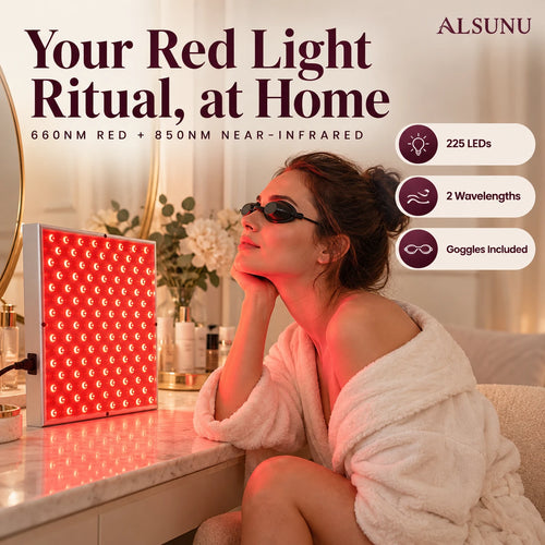Woman in a robe relaxing with eye goggles in front of the glowing red light panel on her vanity at home