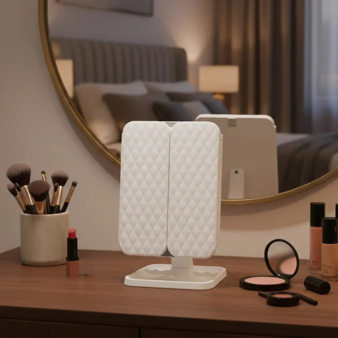 Alsunu trifold LED makeup mirror with quilted white design displayed on a vanity table with cosmetic products
