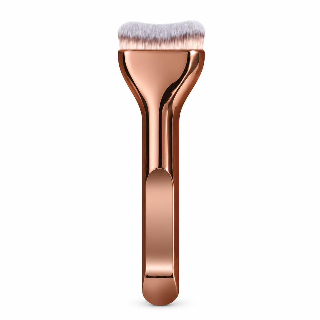 Curved foundation brush with rose gold handle on a white background
